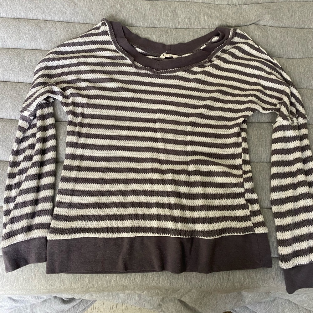 Spandex like material, very comfy and a nice light sweater so you're not too hot